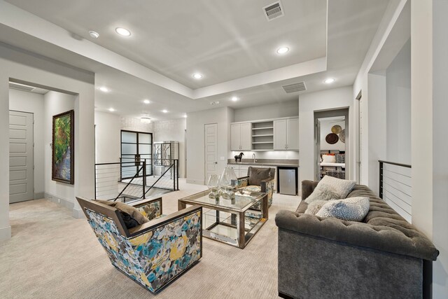 507 Terrace Dr, Houston, TX 77007 - living area featuring light colored carpet, recessed lighting, a tray ceiling, and baseboards