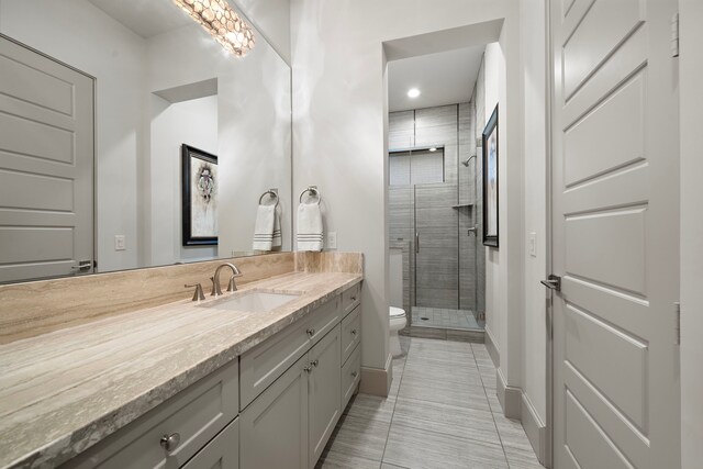 507 Terrace Dr, Houston, TX 77007 - bathroom featuring toilet, vanity, a shower stall, tile patterned floors, and baseboards