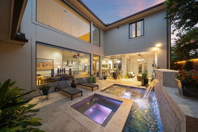 507 Terrace Dr, Houston, TX 77007 - back of house with an in-ground hot tub, stucco siding, and a patio