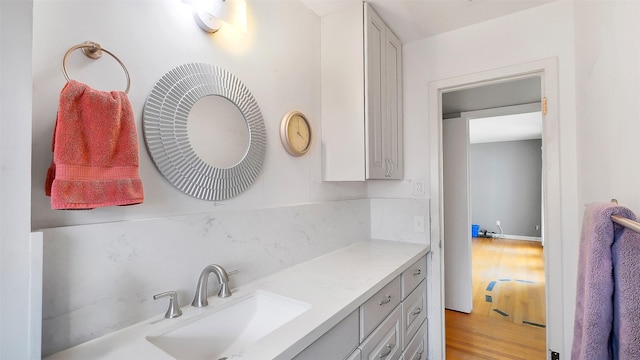 6805 Mobud Dr, Houston, TX 77074 - bathroom with wood finished floors, vanity, and tasteful backsplash