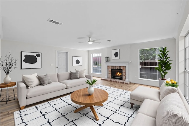 150 Rushwing Pl, The Woodlands, TX 77381 - living room with a ceiling fan, wood finished floors, and a fireplace