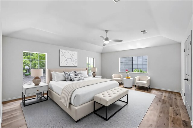 150 Rushwing Pl, The Woodlands, TX 77381 - bedroom with multiple windows, light wood finished floors, vaulted ceiling, and a ceiling fan