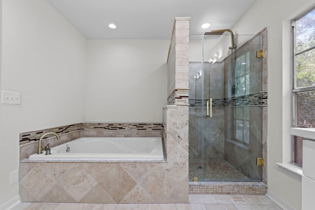 150 Rushwing Pl, The Woodlands, TX 77381 - full bath featuring a garden tub, a shower stall, recessed lighting, and baseboards