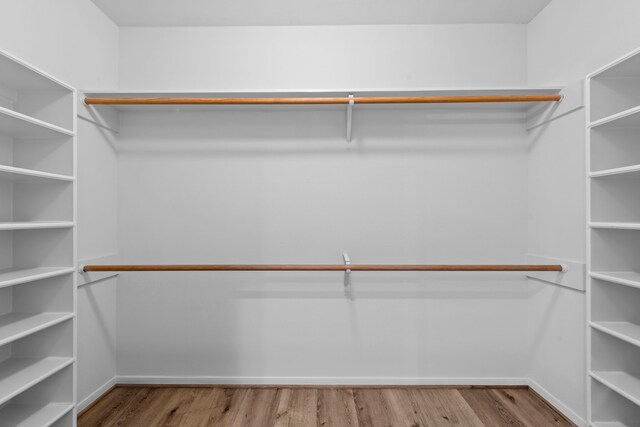 150 Rushwing Pl, The Woodlands, TX 77381 - spacious closet featuring wood finished floors