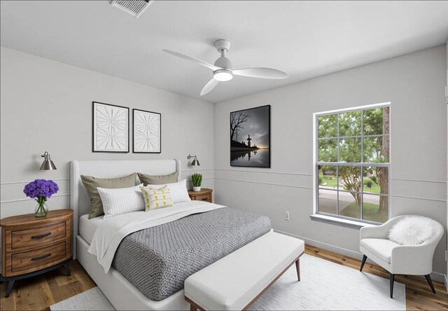 150 Rushwing Pl, The Woodlands, TX 77381 - bedroom with wood finished floors, baseboards, and ceiling fan