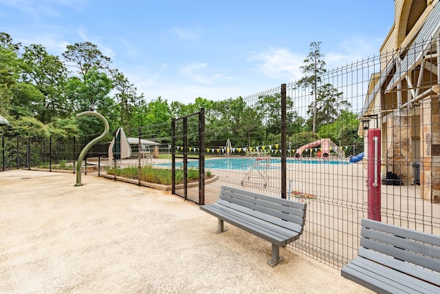 150 Rushwing Pl, The Woodlands, TX 77381 - community pool with a patio and view of wooded area