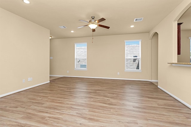 24734 Colonial Maple Dr, Katy, TX 77493 - empty room with ceiling fan, arched walkways, recessed lighting, light wood finished floors, and baseboards