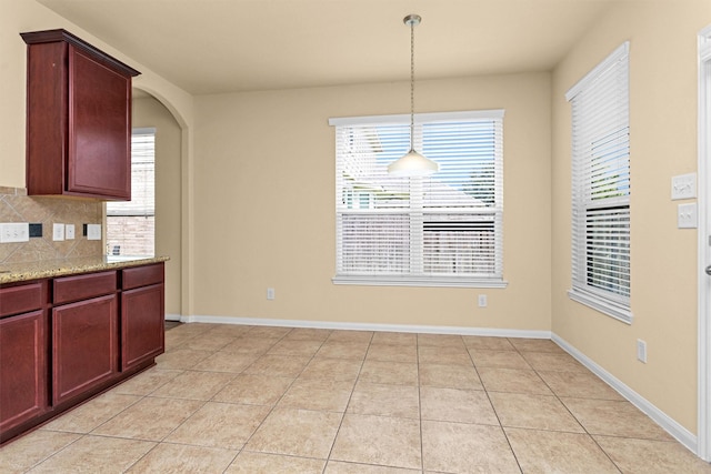 24734 Colonial Maple Dr, Katy, TX 77493 - unfurnished dining area featuring healthy amount of natural light, baseboards, and light tile patterned flooring