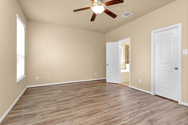 24734 Colonial Maple Dr, Katy, TX 77493 - unfurnished bedroom with light wood-style flooring, baseboards, ensuite bath, and a ceiling fan