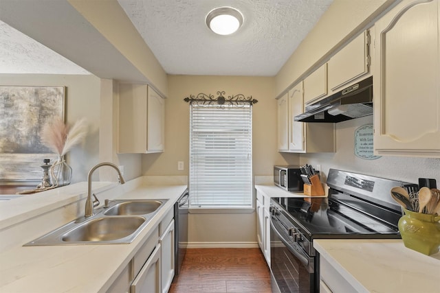 22410 Millgate Dr, Spring, TX 77373 - kitchen with appliances with stainless steel finishes, under cabinet range hood, a sink, a textured ceiling, and baseboards