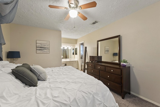 22410 Millgate Dr, Spring, TX 77373 - carpeted bedroom featuring a textured ceiling, ensuite bathroom, baseboards, and ceiling fan