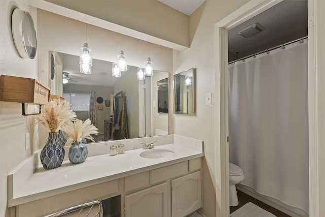 22410 Millgate Dr, Spring, TX 77373 - full bathroom featuring toilet, vanity, a ceiling fan, and a shower with shower curtain