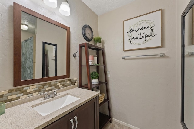 22410 Millgate Dr, Spring, TX 77373 - full bathroom featuring vanity, a textured ceiling, a textured wall, a shower with curtain, and decorative backsplash