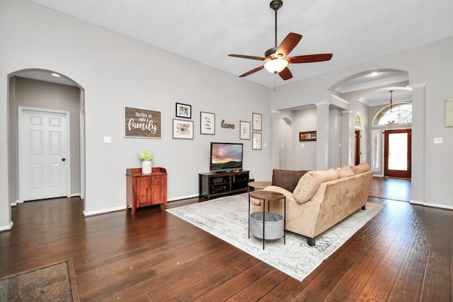 9510 Willowbridge Park Blvd, Houston, TX 77064 - living room featuring arched walkways, a ceiling fan, dark wood-type flooring, decorative columns, and baseboards