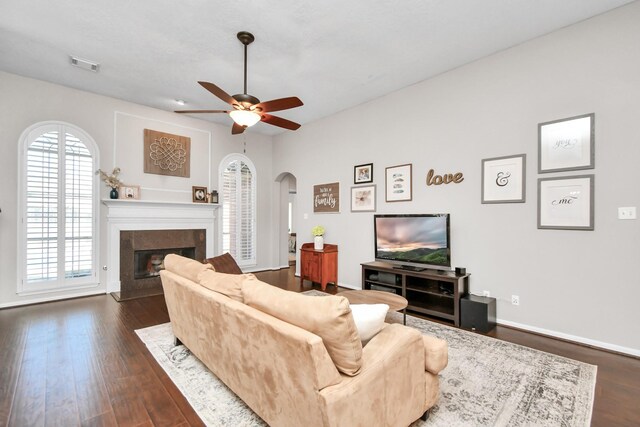 9510 Willowbridge Park Blvd, Houston, TX 77064 - living area with arched walkways, ceiling fan, a premium fireplace, dark wood-style flooring, and baseboards