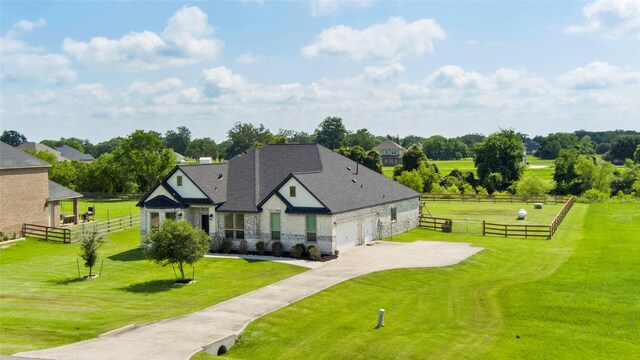 18327 Cypress Hill Dr, Rosharon, TX 77583 - view of front of house featuring stone siding, concrete driveway, roof with shingles, and view of scattered trees