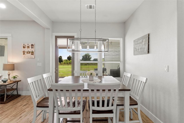 18327 Cypress Hill Dr, Rosharon, TX 77583 - dining area with light wood-type flooring, a chandelier, and baseboards