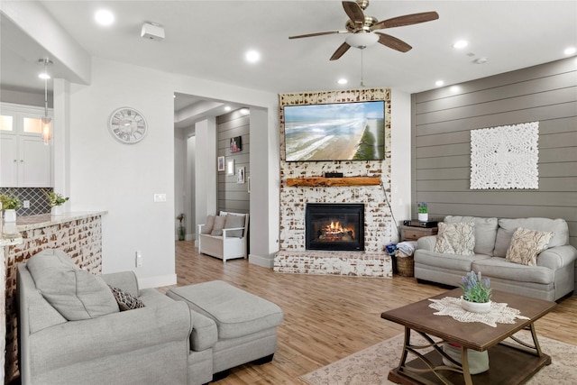 18327 Cypress Hill Dr, Rosharon, TX 77583 - living room featuring ceiling fan, light wood-type flooring, a large fireplace, recessed lighting, and baseboards