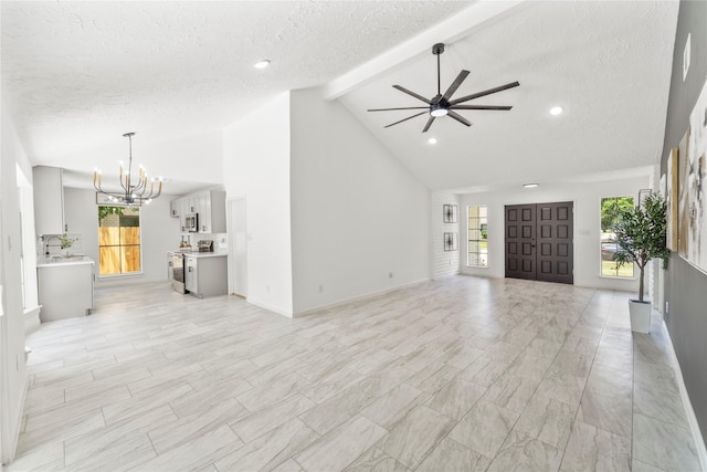 10530 Tenneco Dr, Houston, TX 77099 - unfurnished living room with a chandelier, a ceiling fan, beam ceiling, a textured ceiling, and high vaulted ceiling