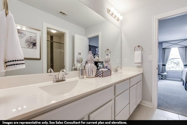 804 Wormwood Dr, League City, TX 77573 - bathroom with double vanity, a shower stall, tile patterned floors, connected bathroom, and baseboards