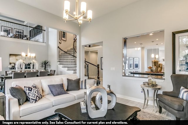 804 Wormwood Dr, League City, TX 77573 - living room with a chandelier, stairs, wood finished floors, baseboards, and a high ceiling