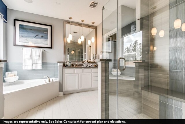 804 Wormwood Dr, League City, TX 77573 - full bathroom with vanity, a garden tub, a stall shower, and tile walls