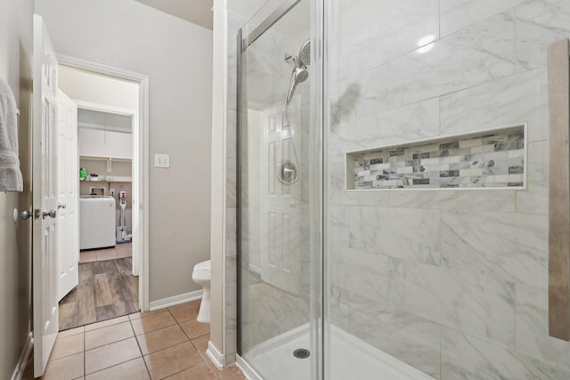 8402 Piping Rock St, Baytown, TX 77523 - full bathroom featuring a shower stall, toilet, baseboards, and tile patterned floors