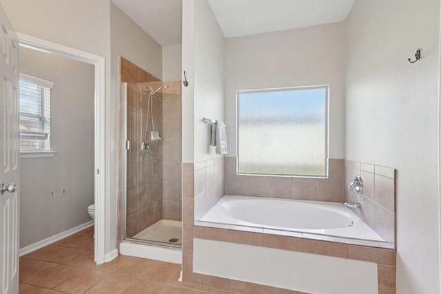 8402 Piping Rock St, Baytown, TX 77523 - bathroom featuring toilet, a bath, a shower stall, and tile patterned floors