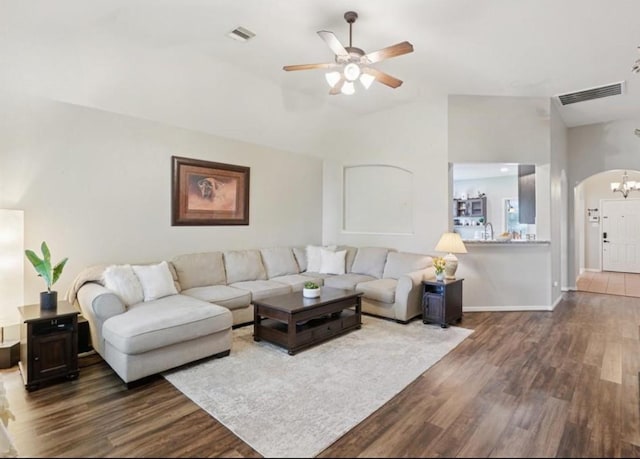 8402 Piping Rock St, Baytown, TX 77523 - living area featuring dark wood finished floors, arched walkways, a ceiling fan, and baseboards