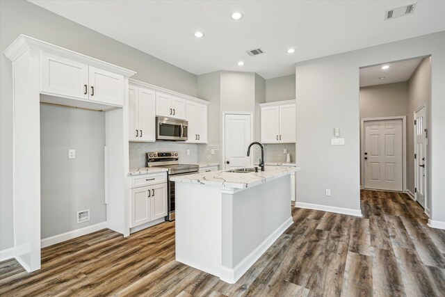 4211 Faulkner St, Houston, TX 77021 - kitchen with appliances with stainless steel finishes, a sink, dark wood-type flooring, white cabinetry, and recessed lighting