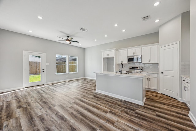 4211 Faulkner St, Houston, TX 77021 - kitchen with stainless steel appliances, a ceiling fan, white cabinets, recessed lighting, and dark wood-style flooring