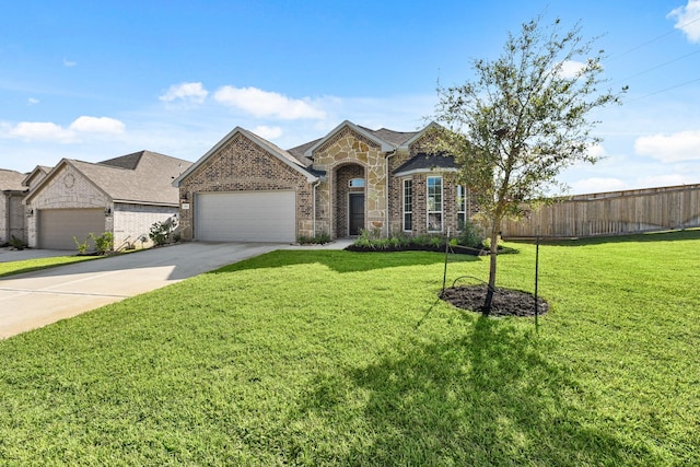104 Dina Ln, Montgomery, TX 77356 - french country inspired facade with an attached garage, driveway, stone siding, and brick siding