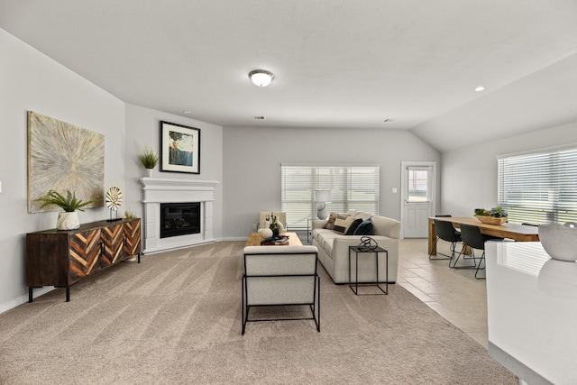 104 Dina Ln, Montgomery, TX 77356 - living area with light carpet, vaulted ceiling, a glass covered fireplace, baseboards, and recessed lighting