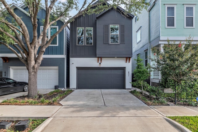 831 E 26th St, Houston, TX 77009 - view of front of house with board and batten siding, a garage, brick siding, and concrete driveway