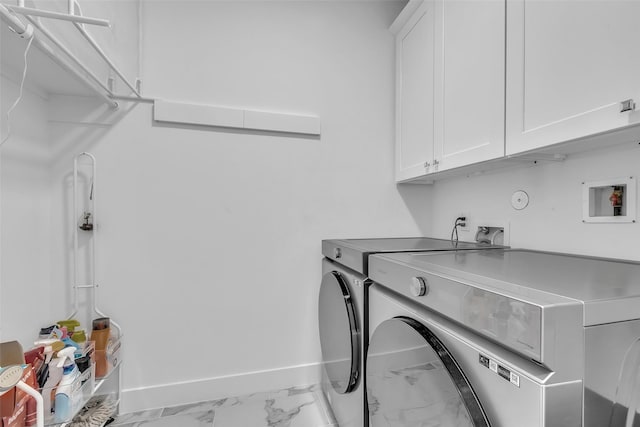 831 E 26th St, Houston, TX 77009 - laundry room with washer hookup, cabinet space, marble look tile flooring, and baseboards