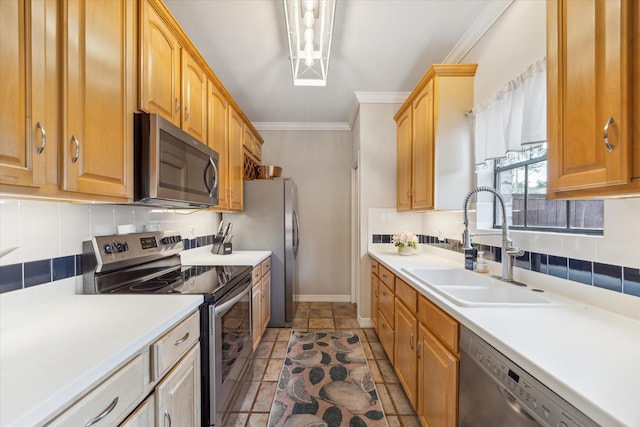 738 Augusta Dr Unit 312, Houston, TX 77057 - kitchen featuring stainless steel appliances, a sink, baseboards, tasteful backsplash, and ornamental molding