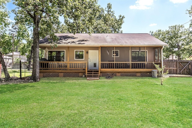 109 Teena Ln, Livingston, TX 77351 - back of property featuring a shingled roof, a sunroom, and a deck