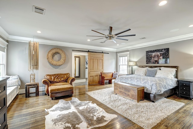 1811 Harvard St, Houston, TX 77008 - bedroom with a barn door, ornamental molding, recessed lighting, baseboards, and wood finished floors