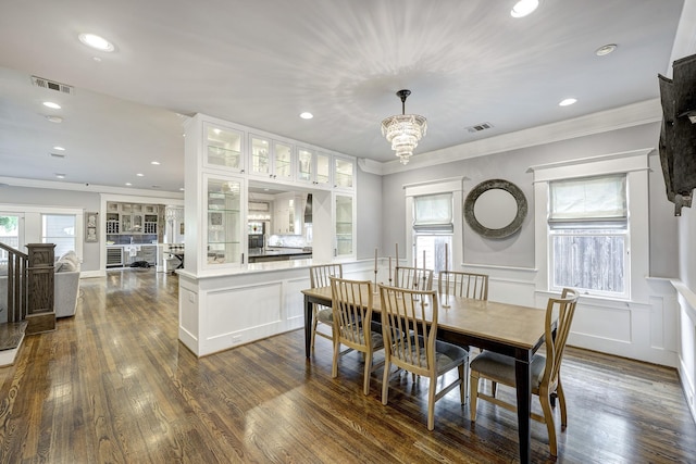 1811 Harvard St, Houston, TX 77008 - dining room featuring ornamental molding, recessed lighting, dark wood-type flooring, a chandelier, and wainscoting
