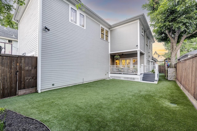 1811 Harvard St, Houston, TX 77008 - back of property at dusk featuring a ceiling fan