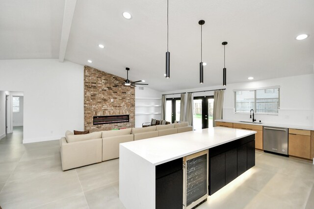 8906 Enchanted Forest Dr, Houston, TX 77088 - kitchen featuring stainless steel dishwasher, wine cooler, a sink, ceiling fan, and a brick fireplace