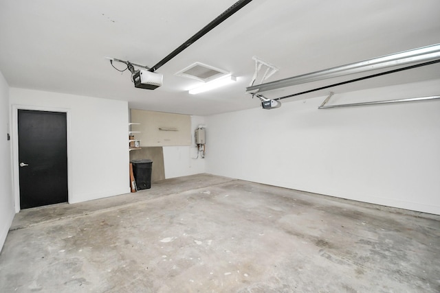 8906 Enchanted Forest Dr, Houston, TX 77088 - garage with a garage door opener and water heater