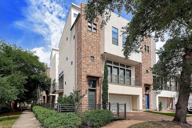1803 Silver St, Houston, TX 77007 - view of building exterior with an attached garage and concrete driveway