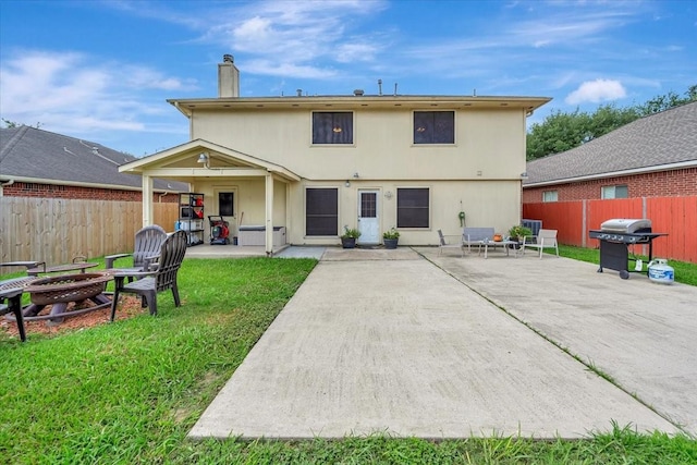 4235 Park Ridge Dr, Pasadena, TX 77504 - rear view of property featuring a patio, an outdoor fire pit, a fenced backyard, and a chimney