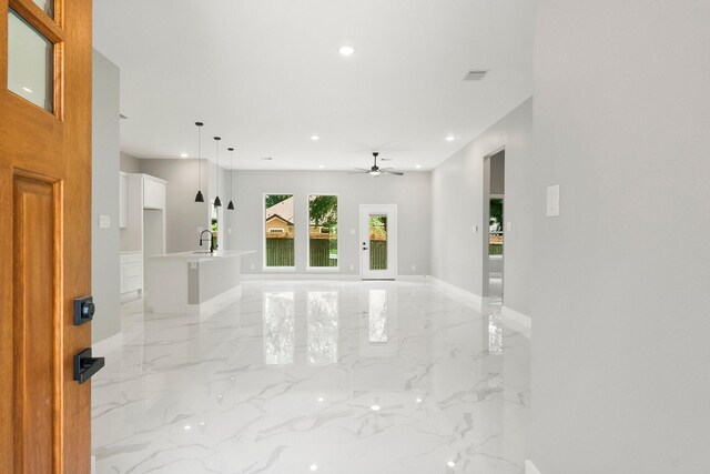 3518 Misty Moss, Montgomery, TX 77356 - unfurnished living room with light marble finish flooring, recessed lighting, baseboards, a ceiling fan, and a sink