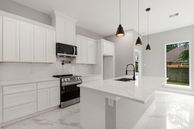 3518 Misty Moss, Montgomery, TX 77356 - kitchen featuring stainless steel appliances, a sink, light marble finish floors, white cabinets, and decorative backsplash