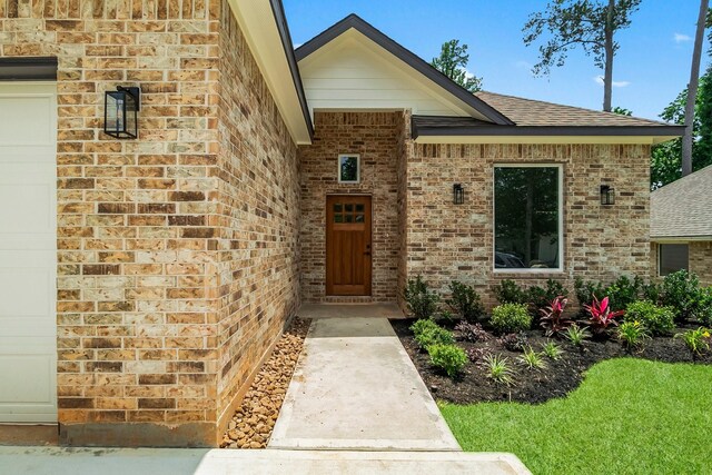 3518 Misty Moss, Montgomery, TX 77356 - view of exterior entry with brick siding and a shingled roof