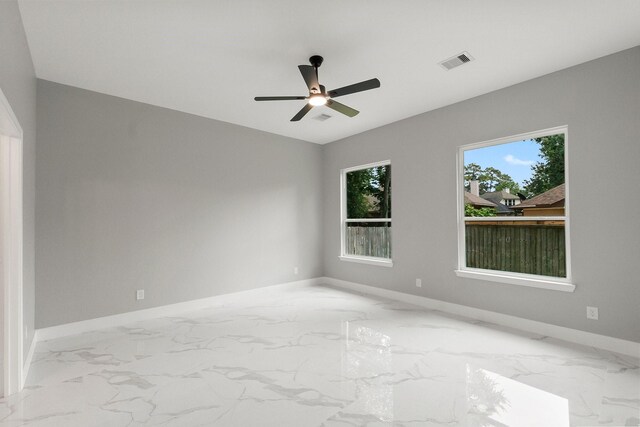 3518 Misty Moss, Montgomery, TX 77356 - spare room featuring baseboards, marble finish flooring, and ceiling fan