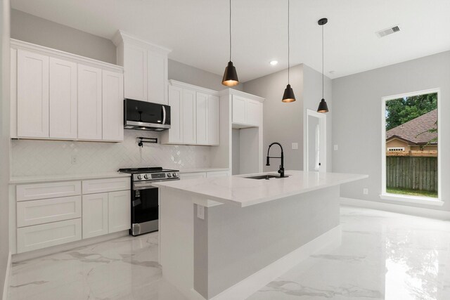 3518 Misty Moss, Montgomery, TX 77356 - kitchen with appliances with stainless steel finishes, a sink, light marble finish floors, an island with sink, and recessed lighting