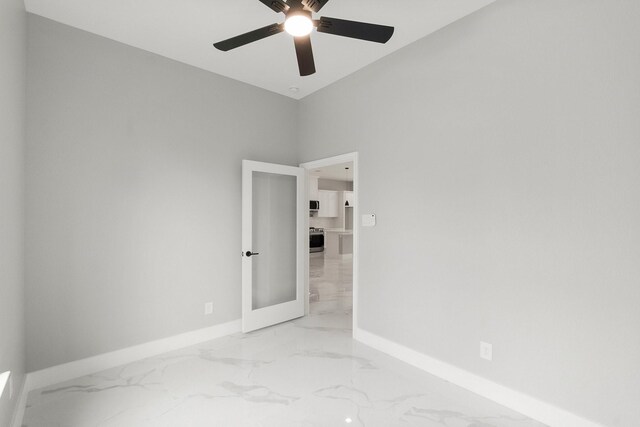 3518 Misty Moss, Montgomery, TX 77356 - empty room featuring light marble finish floors, baseboards, and ceiling fan